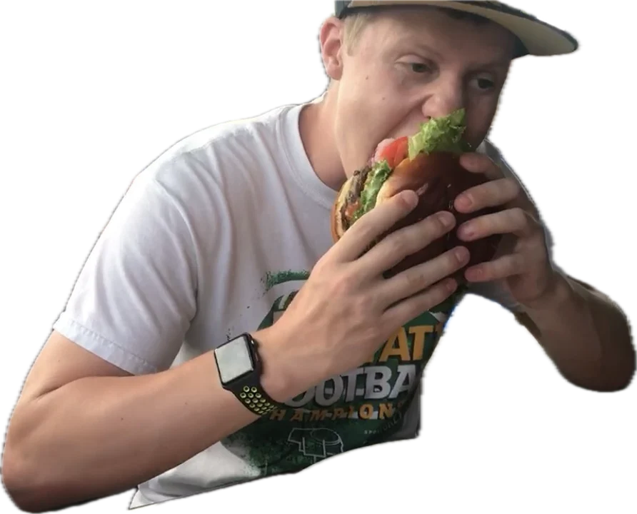 Ben taking a bite out of a burger as big as his head